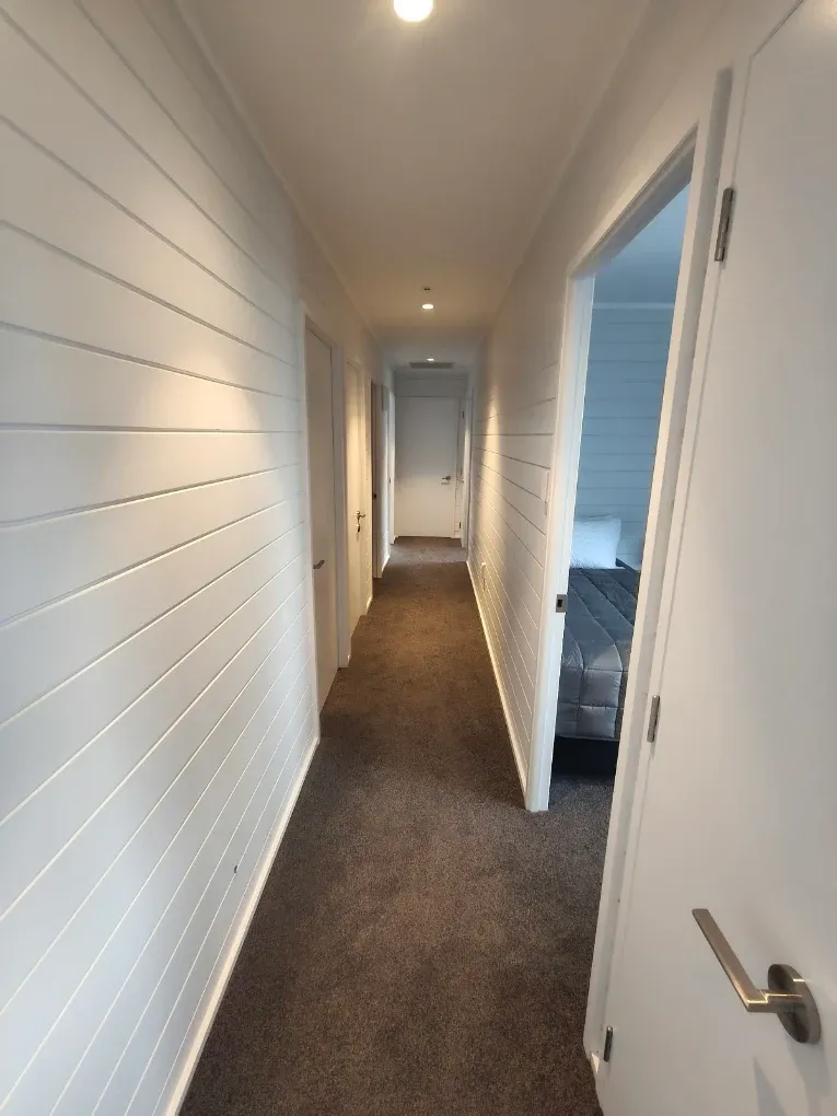 Hallway with white walls and doors